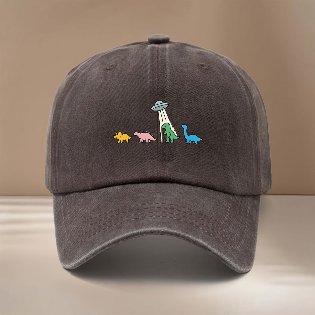 This Is a Baseball Cap with a Dinosaur and UFO Print, Suitable for All Seasons. It Features an Adjustable Size, a Curved Brim, and Is Unisex. The Hat Is Comfortable, Lightweight, and Can Be Worn for Outdoor Sports, Dinners, Camping, or as a  Fashion